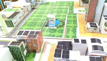 Maquette met groenruimte, gebouwen en wegen in karton